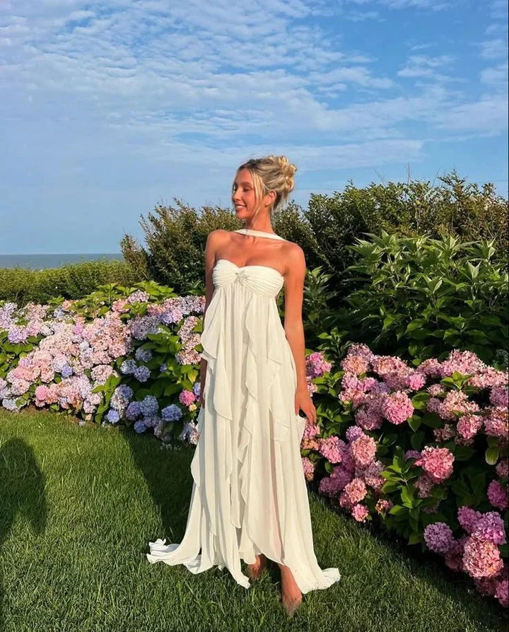 Strapless maxi dress in soft fabric with cascading ruffles, perfect for elegant occasions.