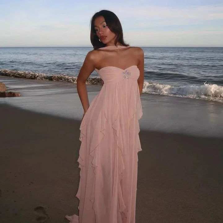 "Strapless maxi dress in navy blue with cascading ruffles, ideal for special occasions, in lightweight chiffon fabric."