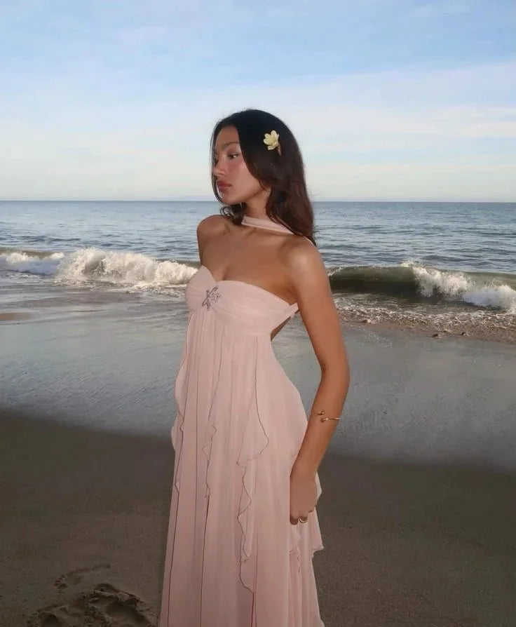Pink strapless maxi dress with flowing ruffles, ideal for a romantic evening. Made of lightweight and breathable fabric.