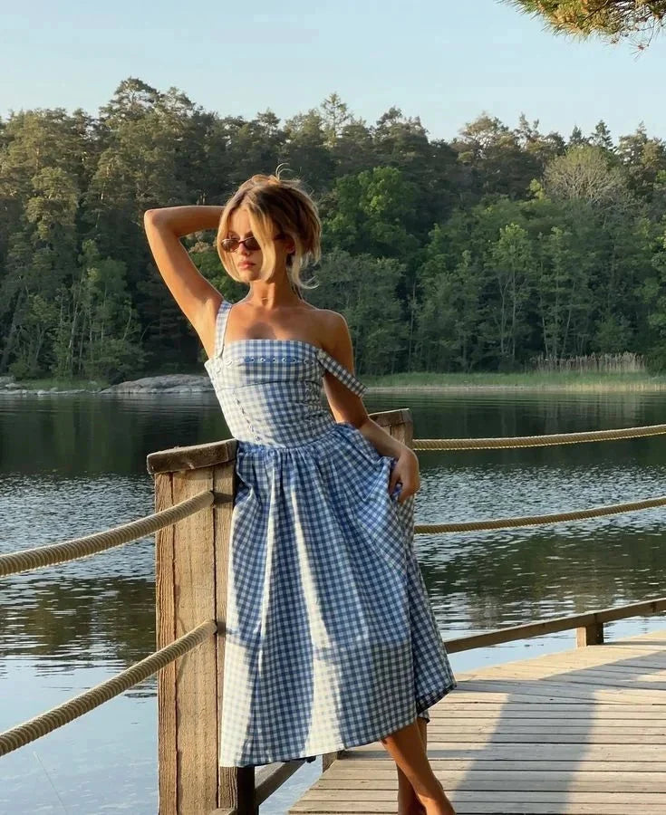Blue gingham off-shoulder Georgette mid-length dress for women, features a stylish off-shoulder design in a classic blue…