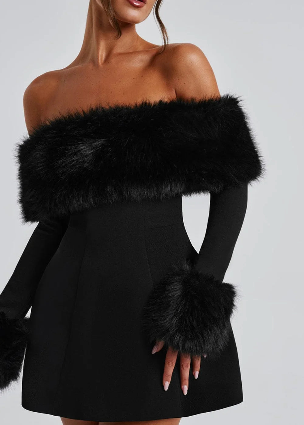 Black mini dress featuring faux fur details, perfect for adding a touch of sophistication and style to your outfit.