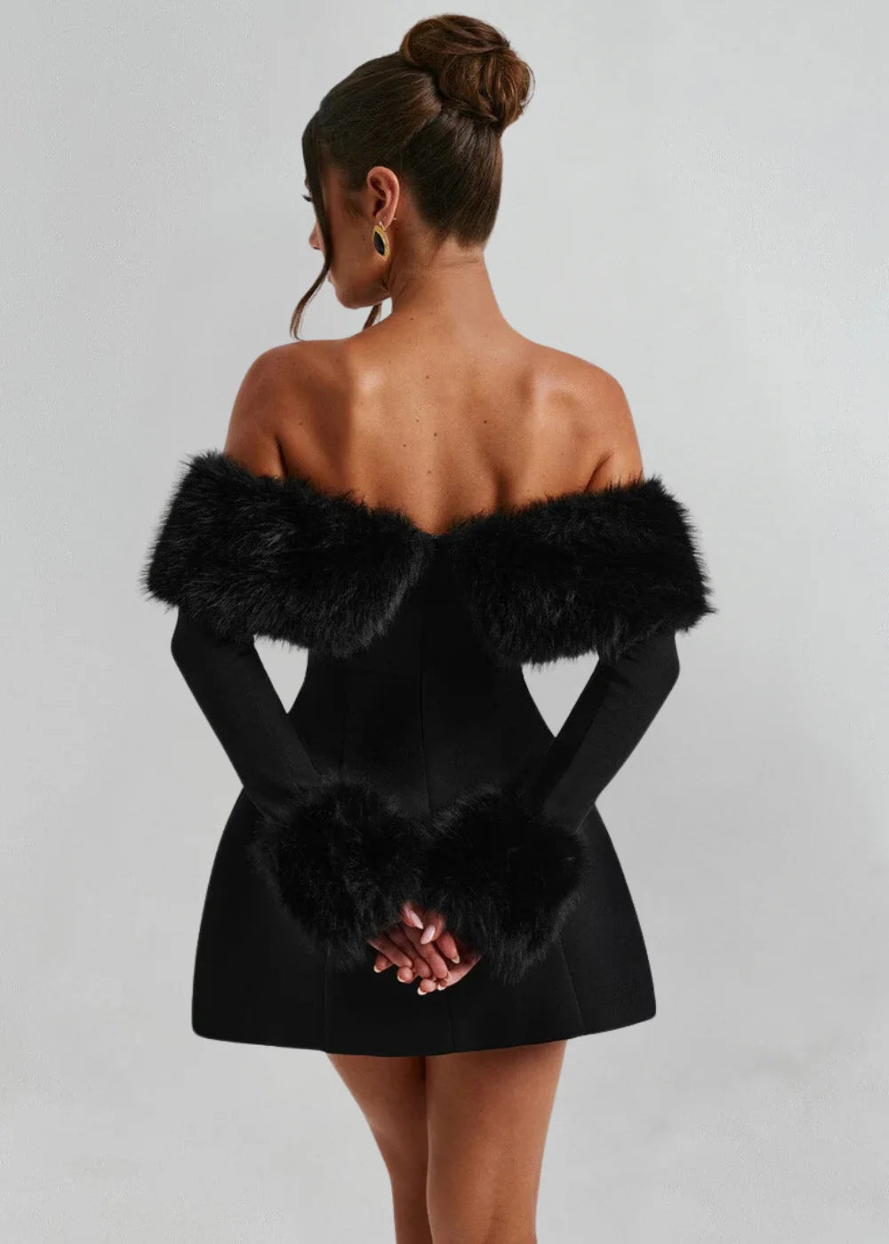 "Black mini dress with fuzzy fur collar and cuffs, perfect for a night out"