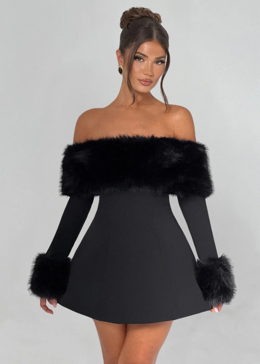 Black mini dress with faux fur details, perfect for a chic and cozy look. Street style fashion with a touch of elegance.