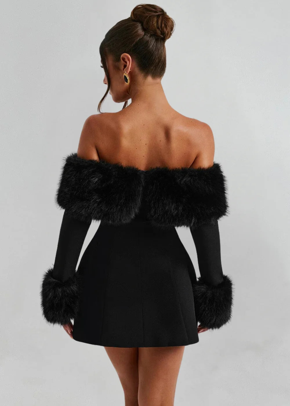 "Black mini dress featuring chic fur details, perfect for a sophisticated and trendy look."