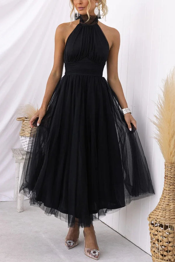 Flowy pleated mid-length black dress with a sophisticated design, ideal for any occasion. Made from soft, breathable fabric…