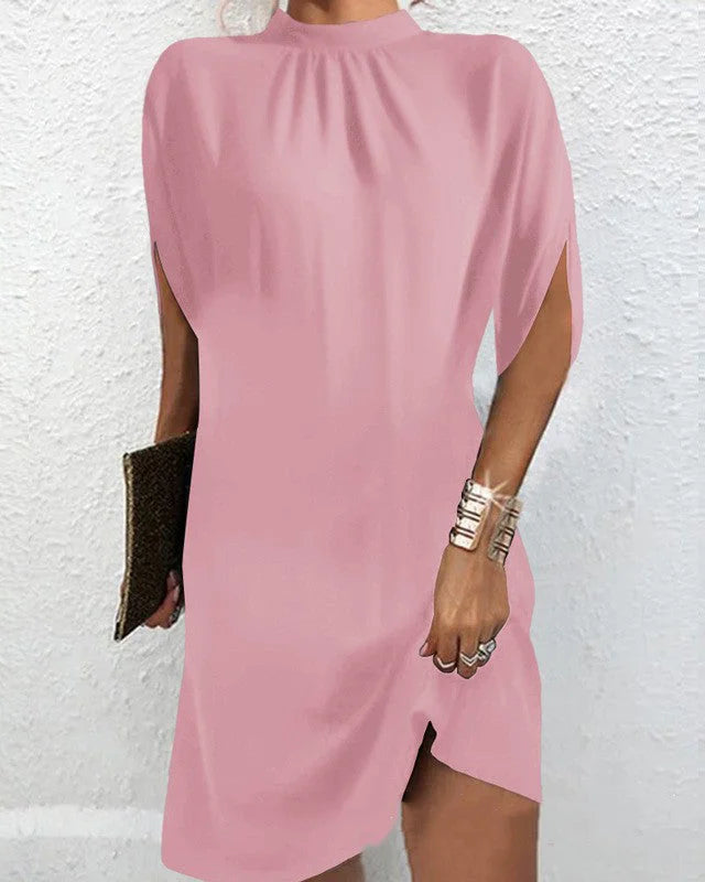 Pink batwing sleeve mini dress by Icelyn, made from soft cotton blend. Features a flowy design and flattering silhouette.