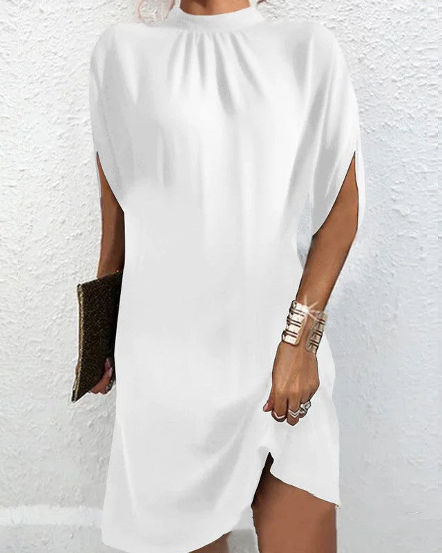 White batwing sleeve mini dress in soft cotton blend. Features V-neckline and relaxed fit. Perfect for a casual yet stylish…