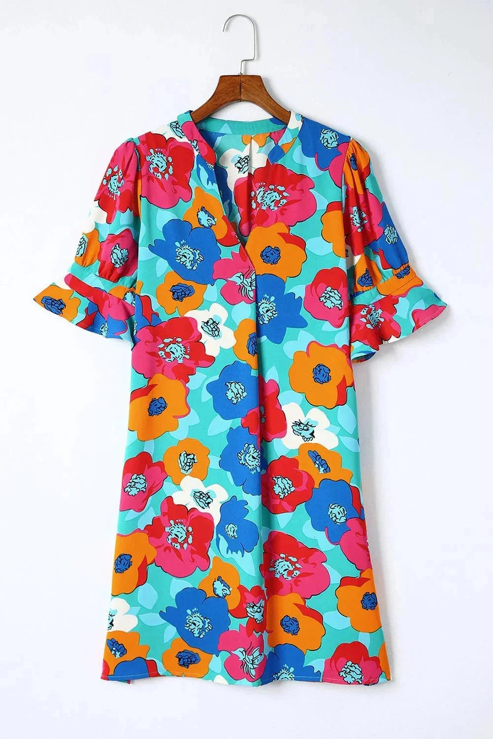 Light blue V-neck dress with flowy sleeves, ideal for summer. Feminine and airy design perfect for warm weather outings.