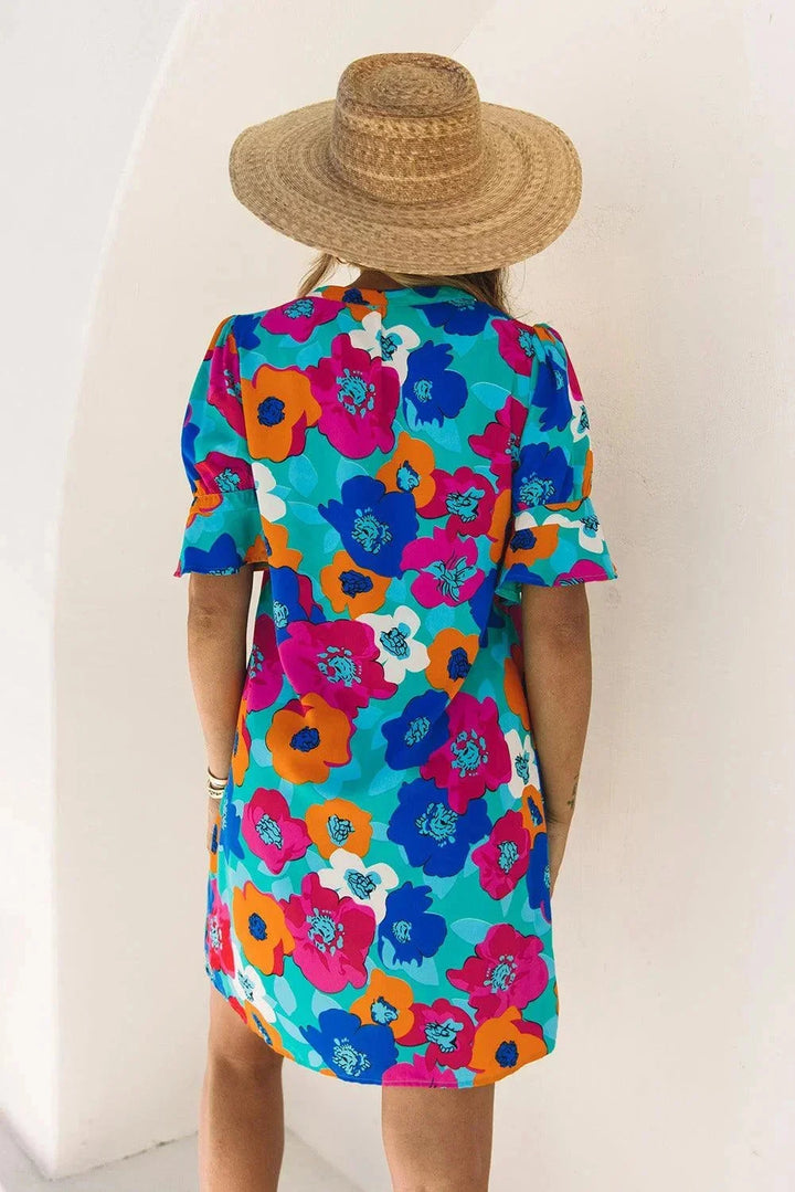 V-neck light dress with flowing sleeves, perfect for summer, made with breathable fabric in a soft neutral hue.