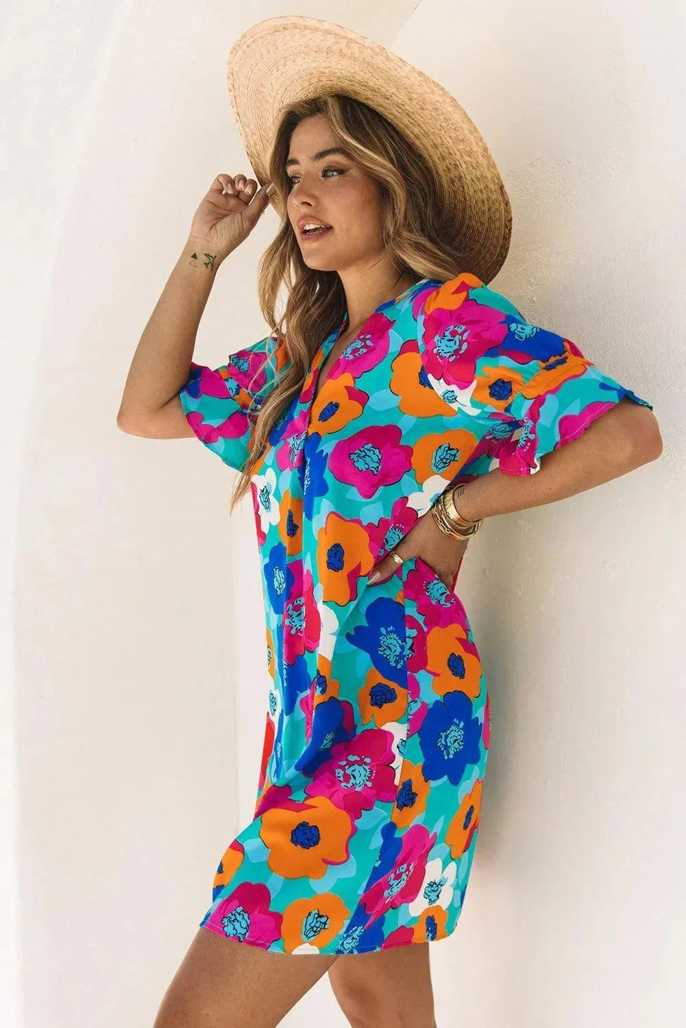 Vibrant light V-neck dress with breezy sleeves, perfect for summer outings, made of soft flowy fabric with a relaxed…