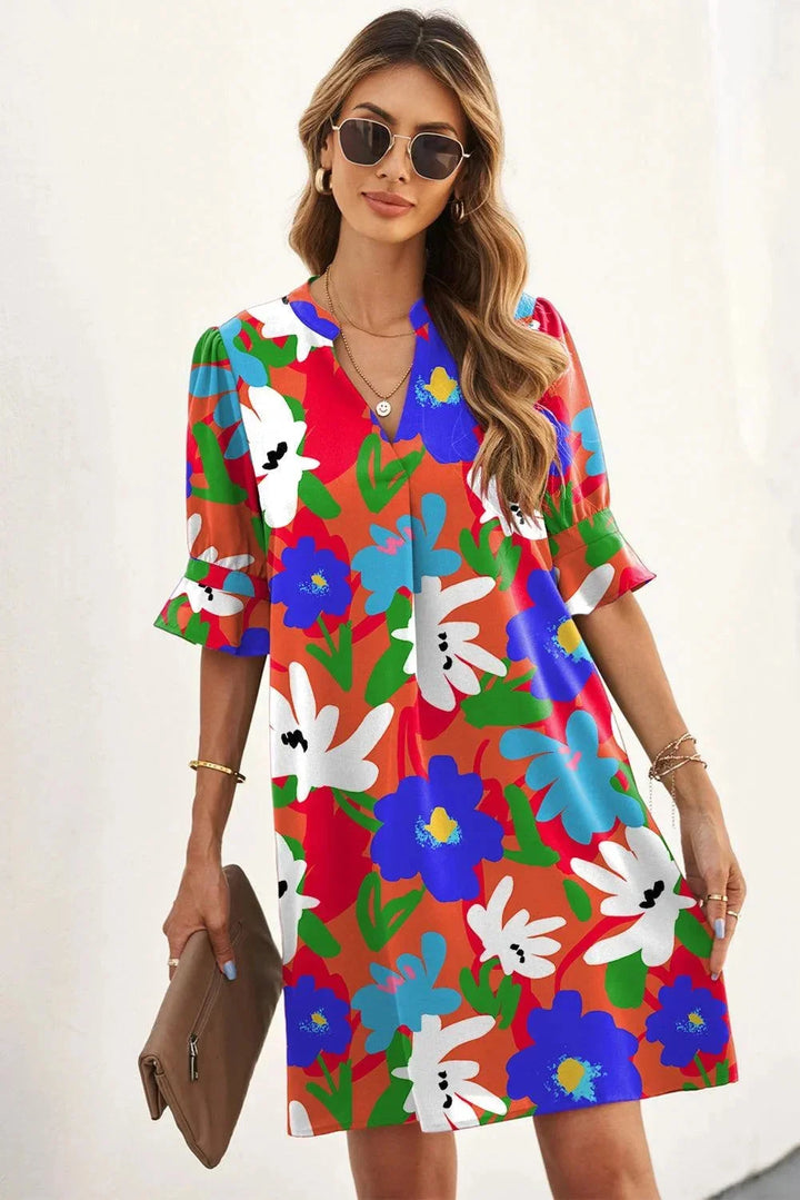 "Orange V-neck dress with breezy sleeves, perfect for casual days. Light and airy material with a relaxed fit."