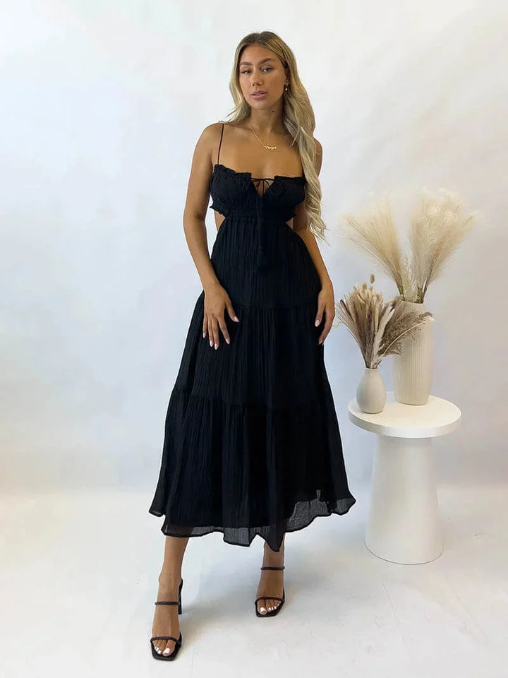Black spaghetti strap maxi dress by Iveth. Features adjustable straps and a flowy design in a soft and comfortable fabric.