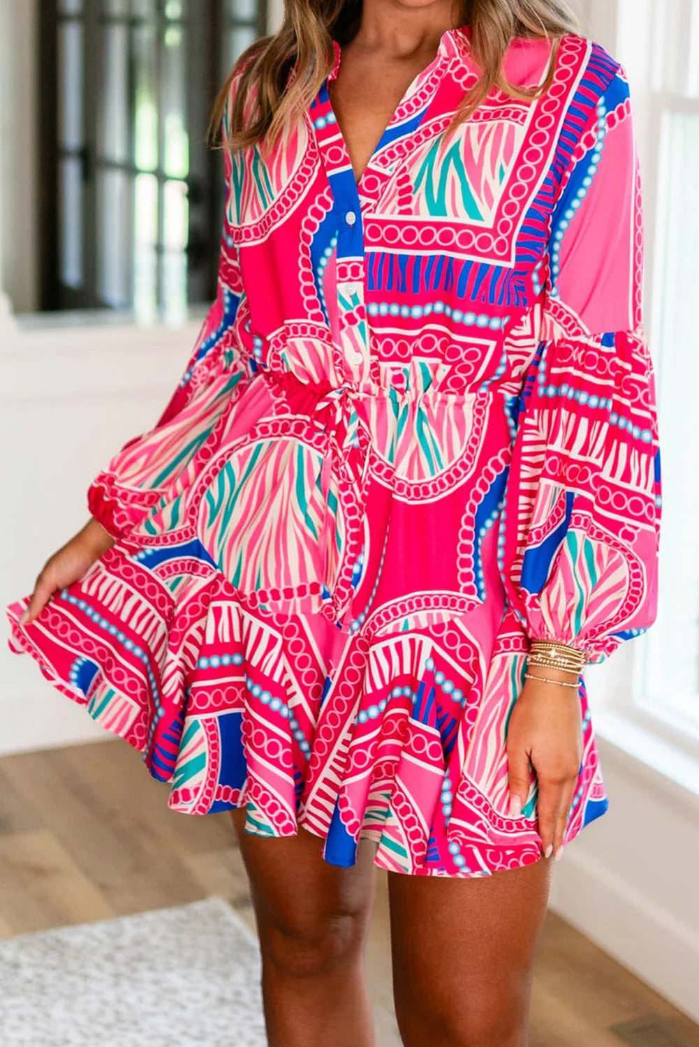 Pink tribal print dress with drawstring waist, made of lightweight cotton blend. Features vibrant print and practical…