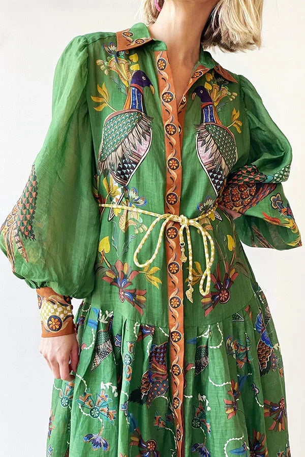 Green bird print midi dress with buttons, perfect for women. The dress is stylish and elegant, featuring a unique bird print…