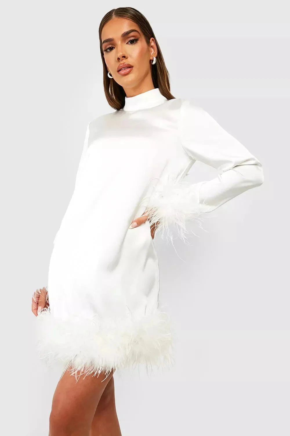 White mini dress for women with feather cuffs, a chic and elegant design perfect for special occasions.