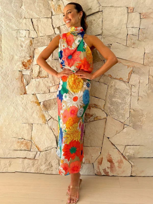 Halter neck midi dress with vibrant floral print on a flowing fabric, perfect for a casual day out or special occasion.