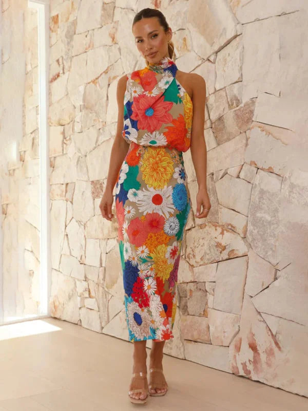 Halter neck midi dress with colorful floral print, perfect for summer outings, made of lightweight breathable fabric.