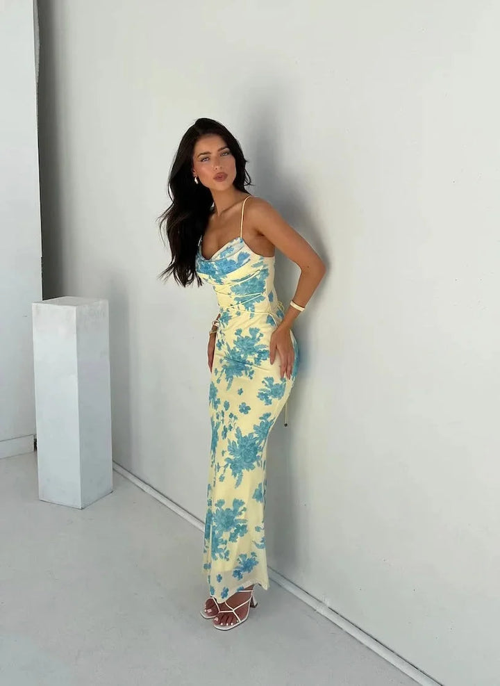Women's yellow floral slim-fit maxi dress with a vibrant floral print, perfect for summer occasions.