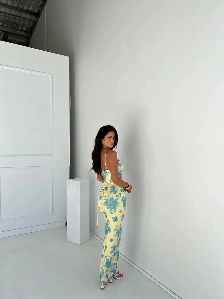 Yellow floral slim-fit maxi dress for women by Jaslynn with a beautiful floral pattern, slim-fit design, and vibrant yellow…
