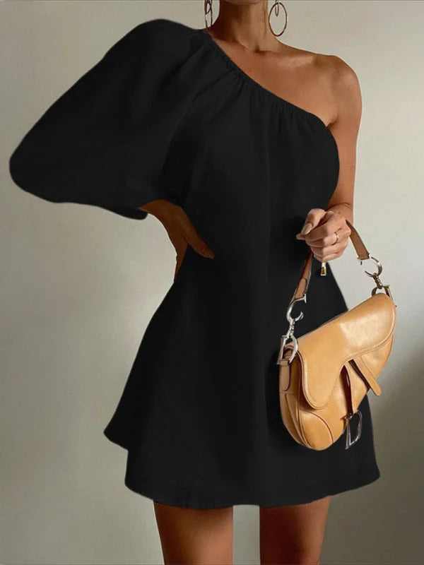 Black dress with puffed sleeves and flared silhouette, made from soft and stretchy fabric.