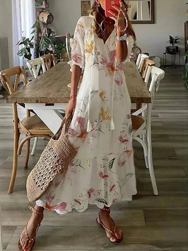 "Jessia - Flowy floral maxi dress with sleeves in soft, lightweight fabric, featuring a vibrant floral pattern and elegant…