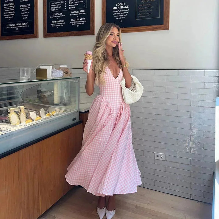 "Sleeveless pink plaid midi dress with pockets, perfect for casual outings, made from soft and breathable fabric."
