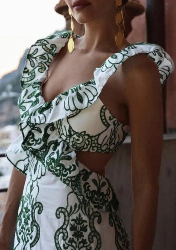 White and green ruffled maxi dress with a floral design, perfect for a summery look.