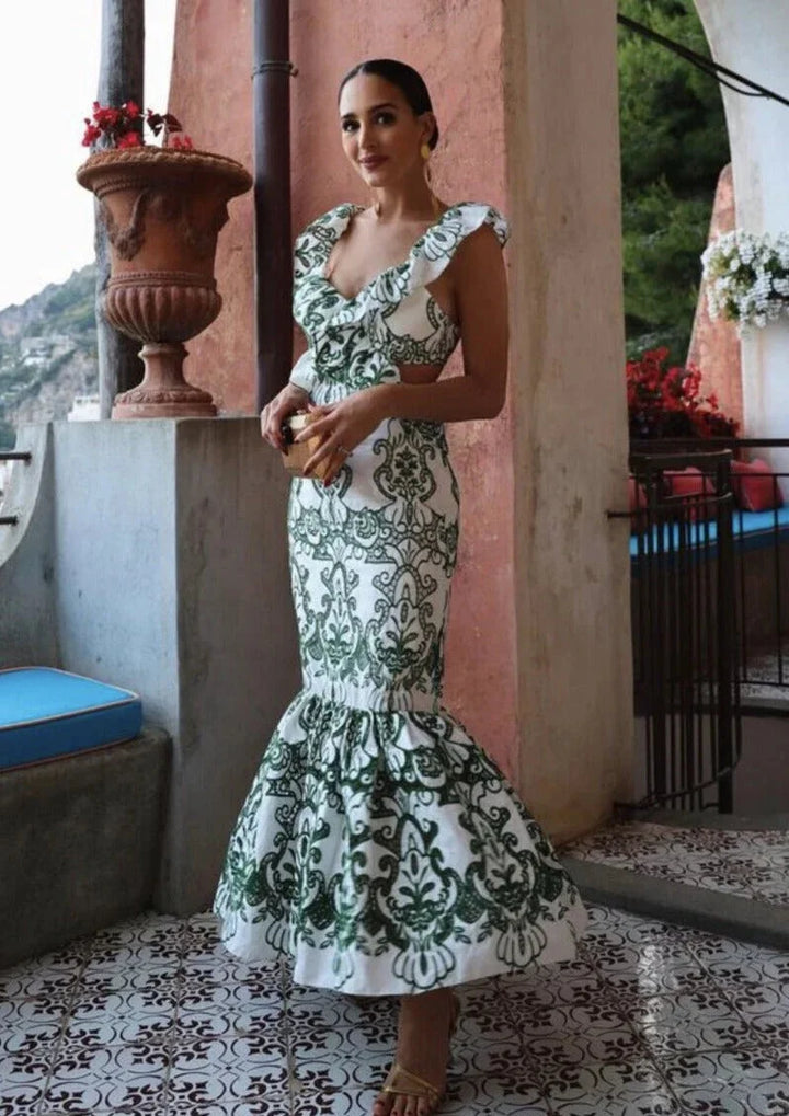 White and green ruffled maxi dress made from lightweight fabric, perfect for a summery look.