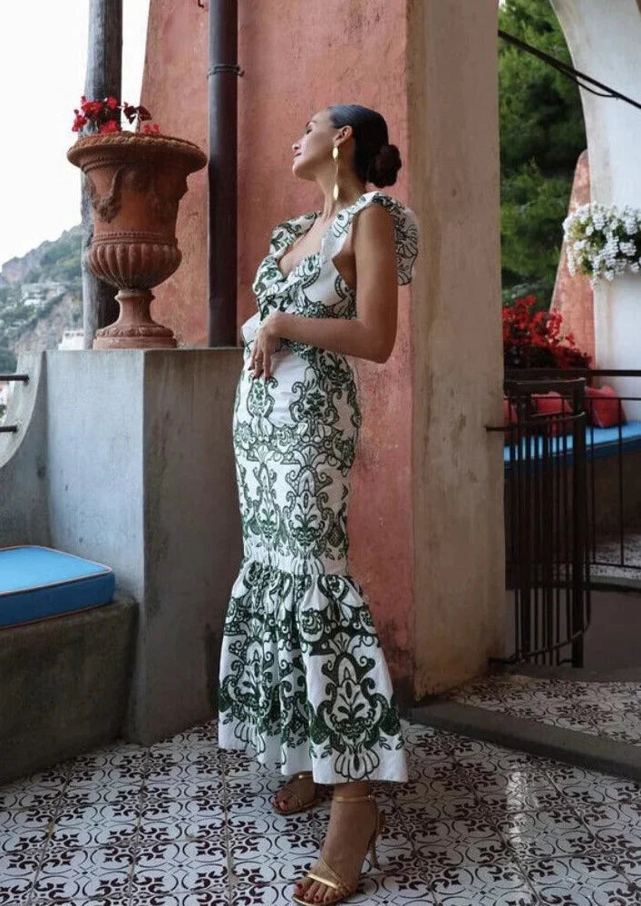 "White and green ruffled maxi dress made from lightweight fabric with a flowy silhouette, perfect for outdoor gatherings and…