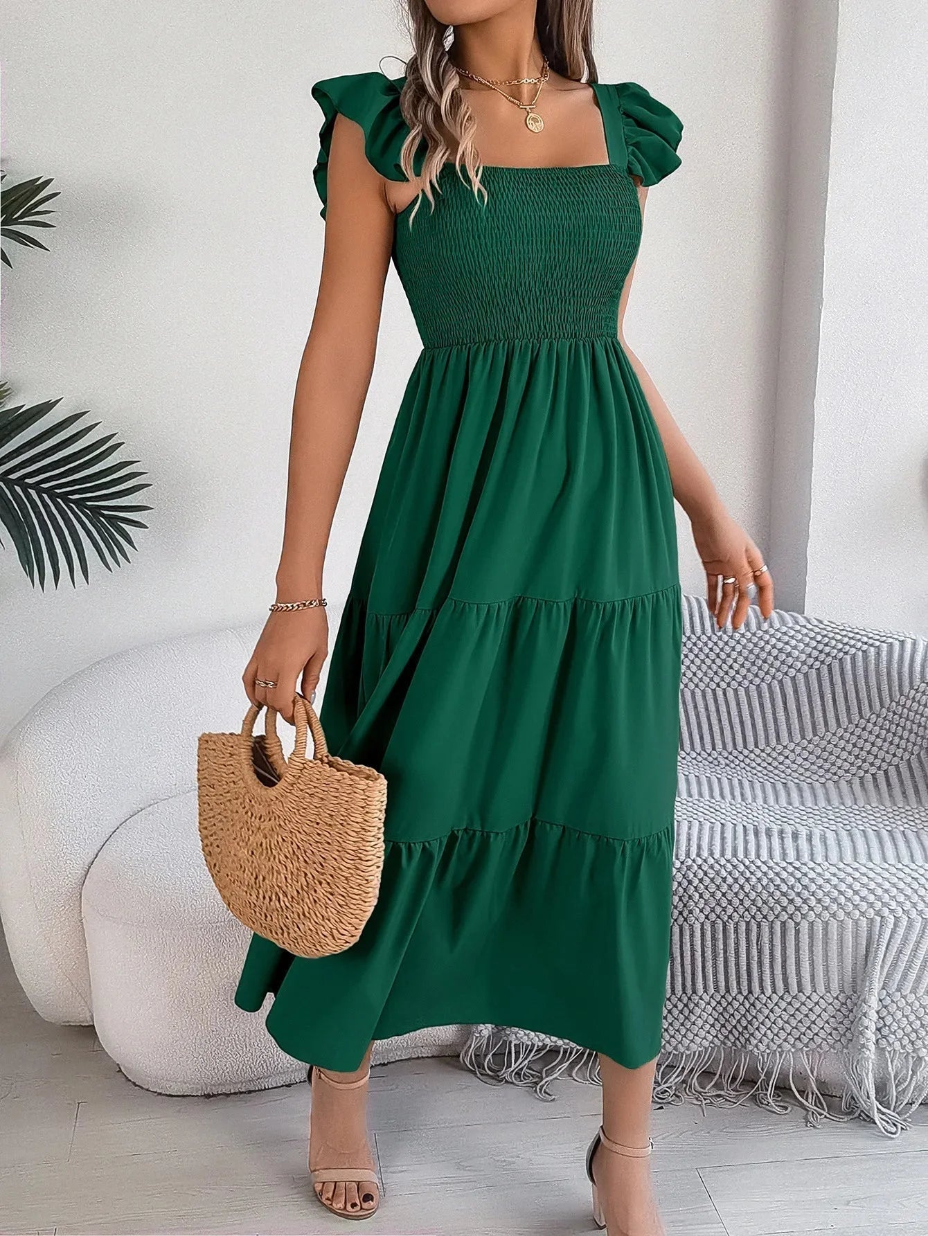 Green smocked midi dress with tiered ruffle detailing - perfect for a charming summer look with a comfortable and breathable…