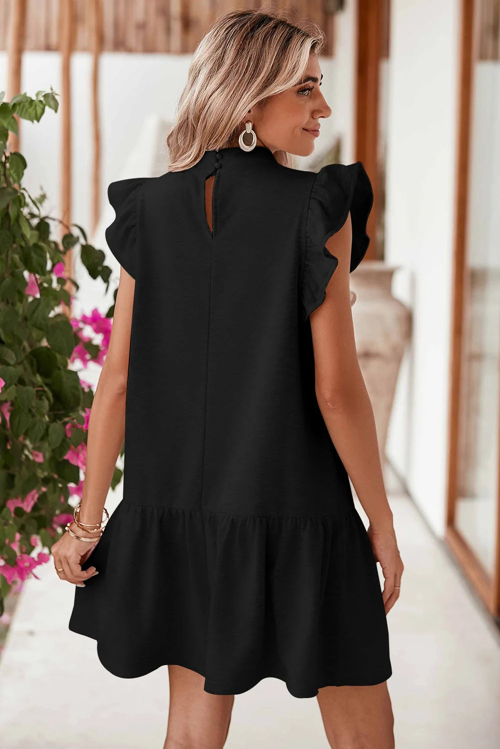 "Black shift dress with stylish ruffle sleeves by Jordan. Soft and flowy fabric perfect for every occasion."