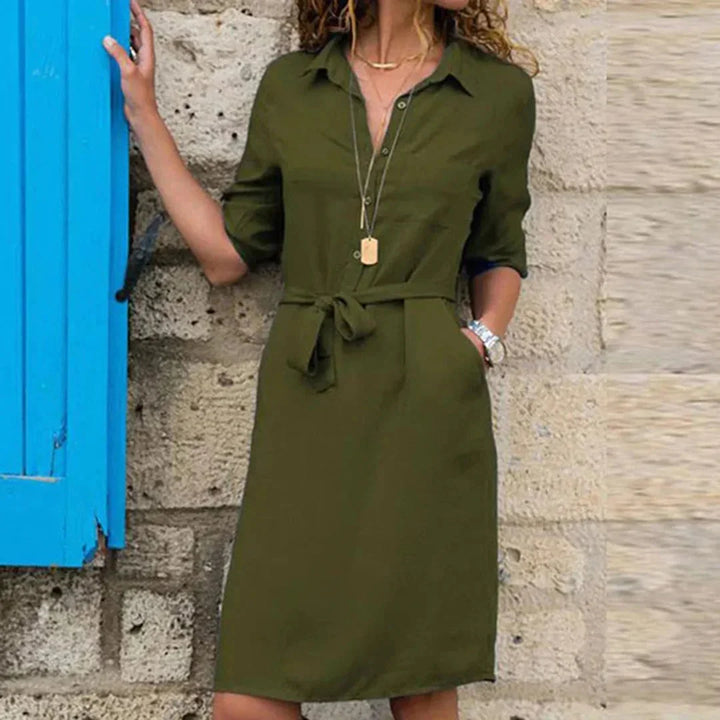 Army green women's shirt dress with belt detailing, crafted from lightweight fabric. Features a tailored fit for a…