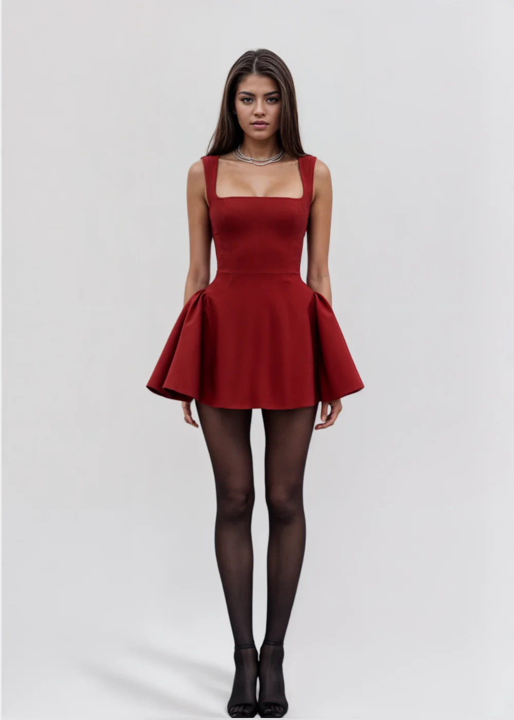 Red sleeveless fit-and-flare mini dress made from soft, stretchy fabric with a classic silhouette perfect for any occasion.