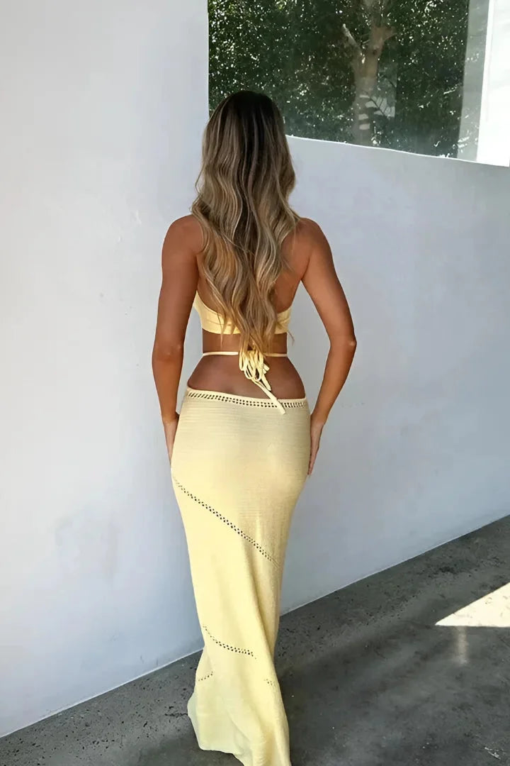 Yellow knit halterneck maxi dress for women, featuring a comfortable and stylish design perfect for summer outings or casual…