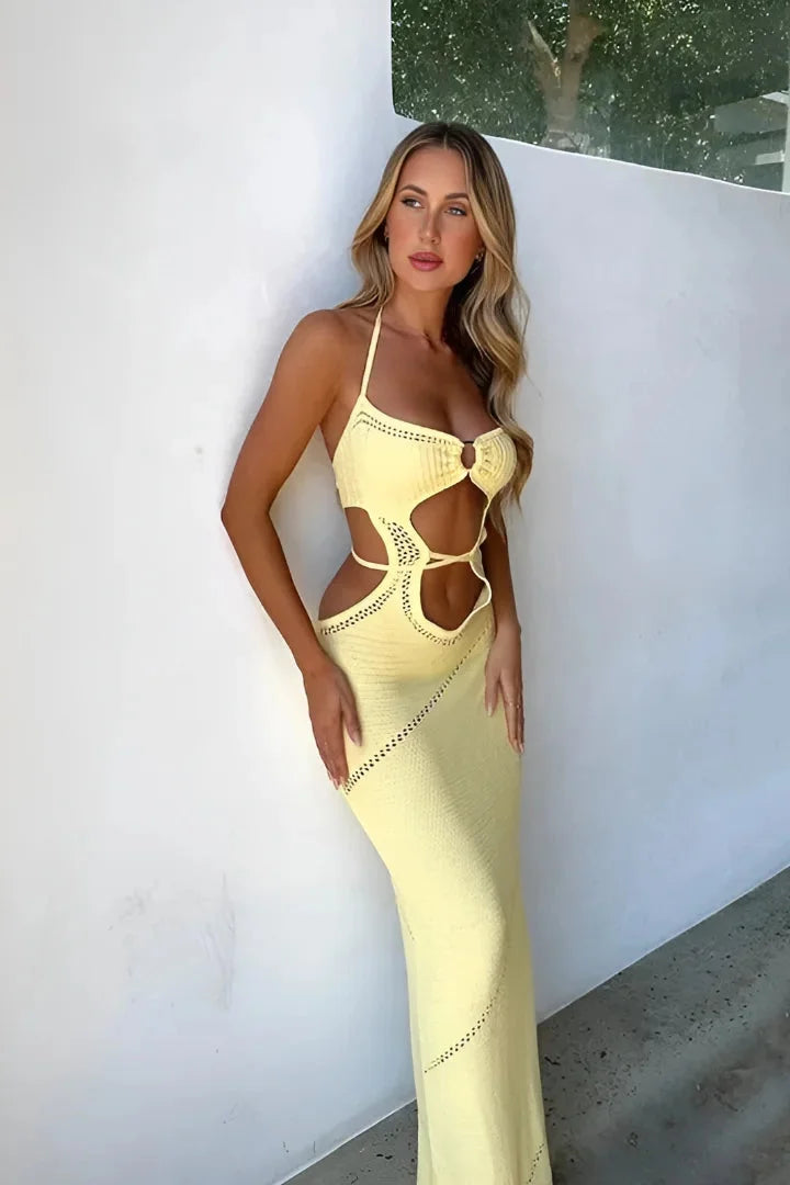Yellow knit halterneck maxi dress for women. Features a soft and cozy knit fabric with a flattering halterneck design for a…