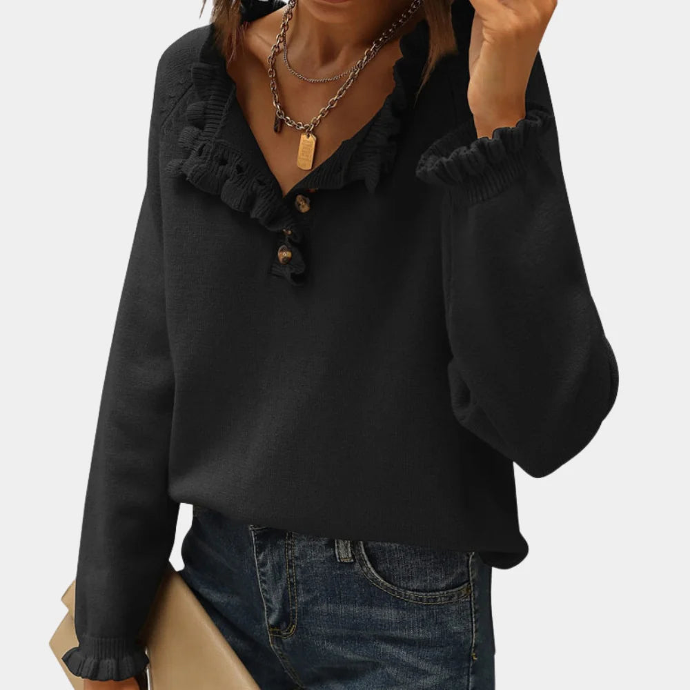 Karla black pullover with ruffle collar, long sleeves, and soft knit fabric.