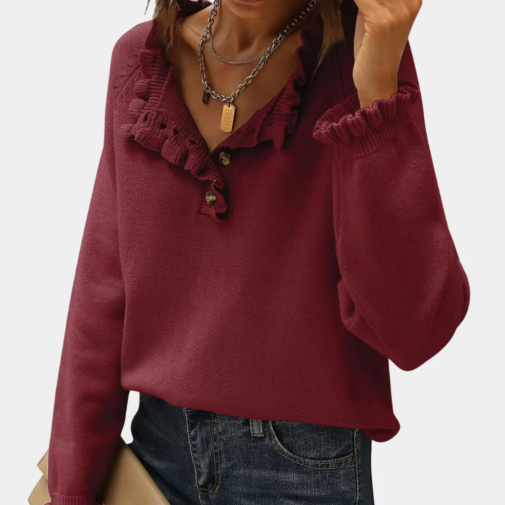 Red long sleeve pullover made with soft knit fabric. Features a stylish ruffle collar for a chic and cozy look.