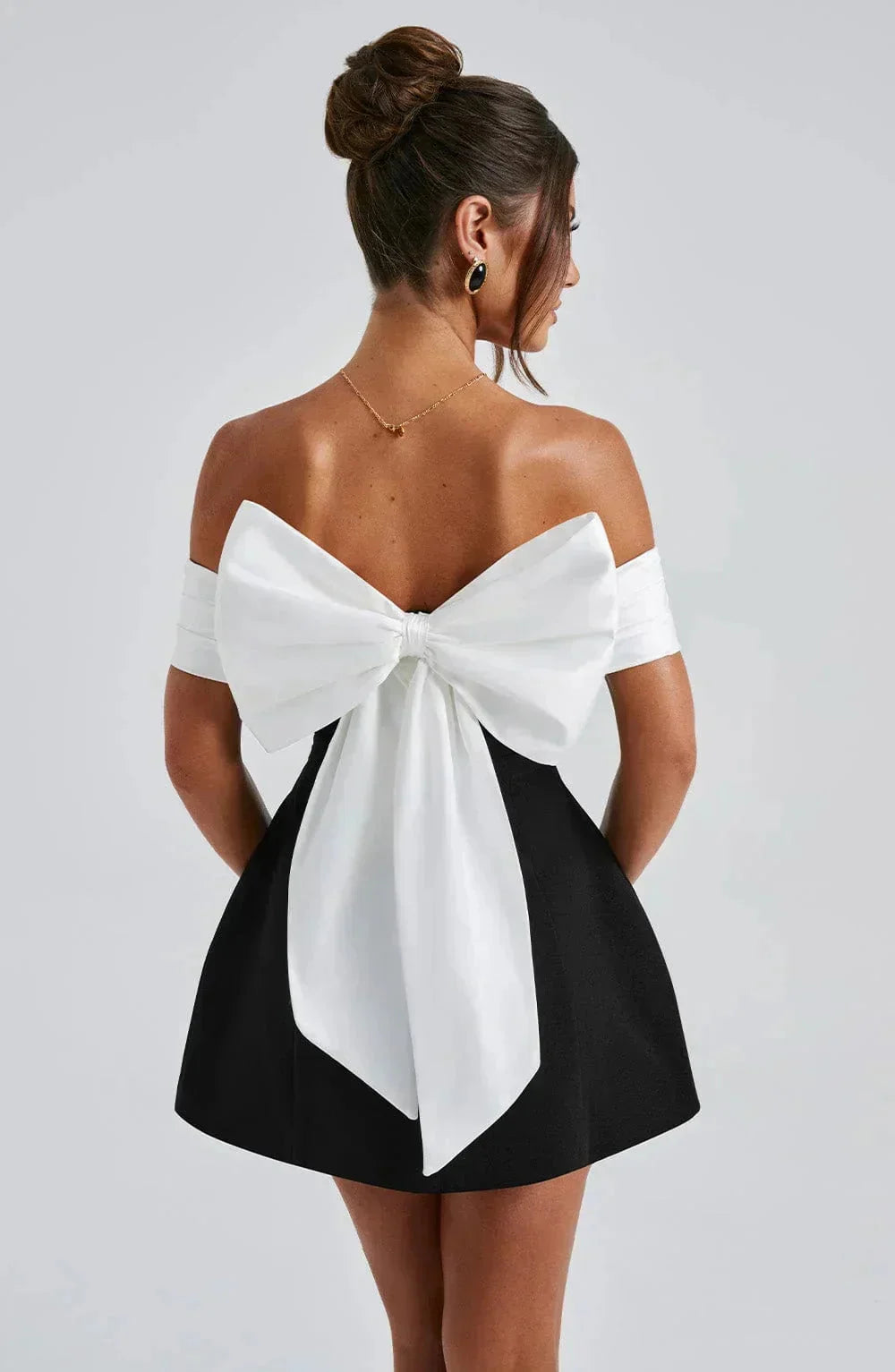 Women’s black and white bow mini dress made of soft cotton blend with a stylish bow detail, perfect for casual yet chic…
