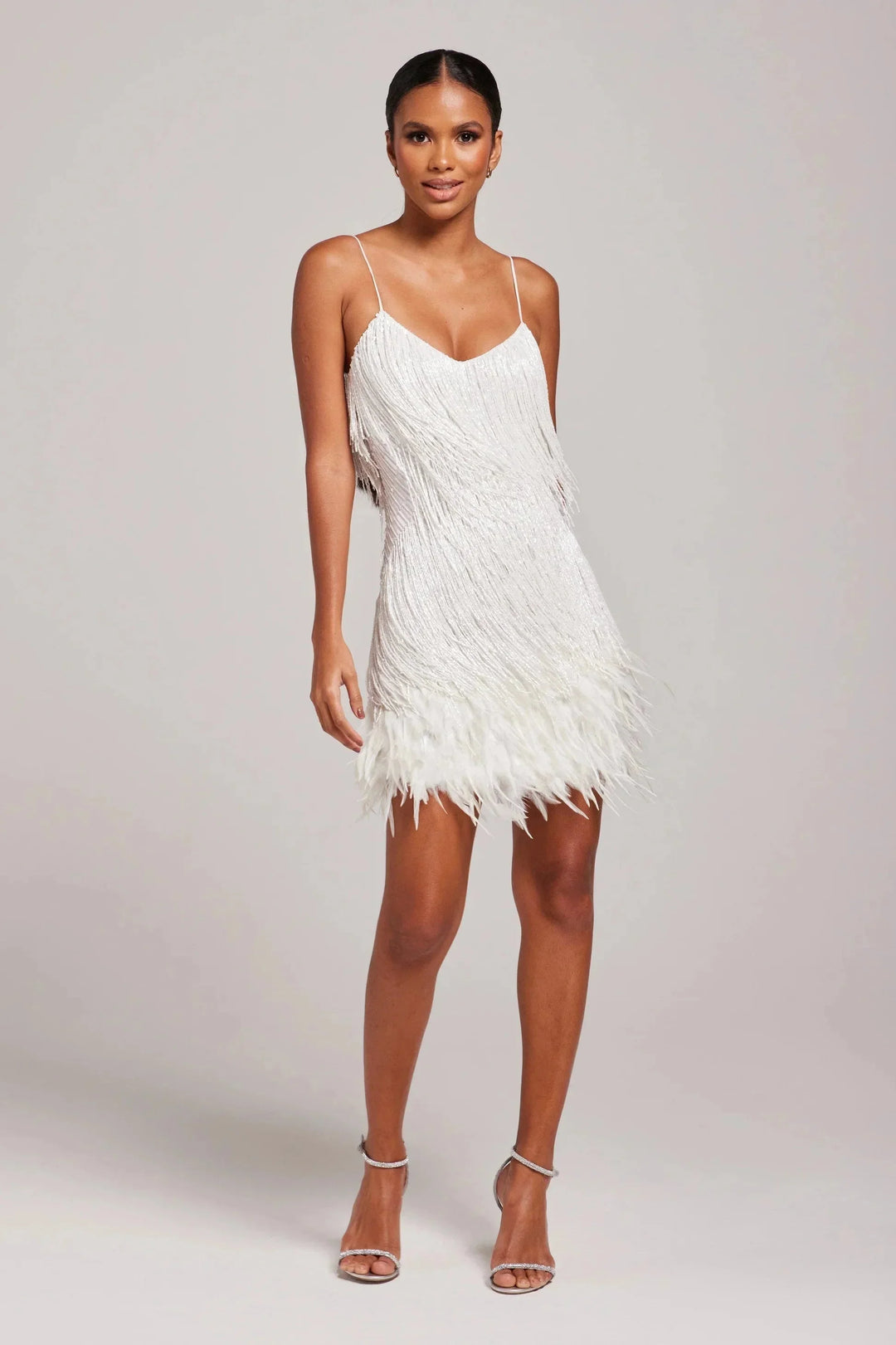 Women's textured mini dress with delicate feather accents, perfect for a stylish and elegant look for any occasion.
