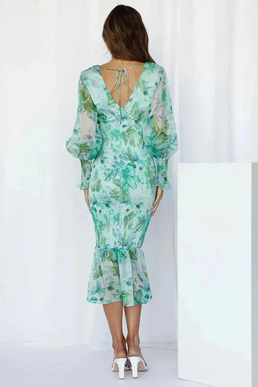 "Kirsten floral midi dress in white with flared sleeves, featuring a delicate flower pattern and a comfortable, lightweight…