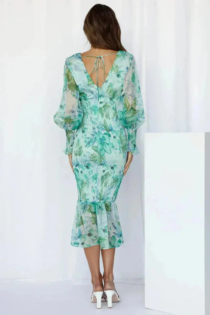 "Kirsten floral midi dress in white with flared sleeves, featuring a delicate flower pattern and a comfortable, lightweight…