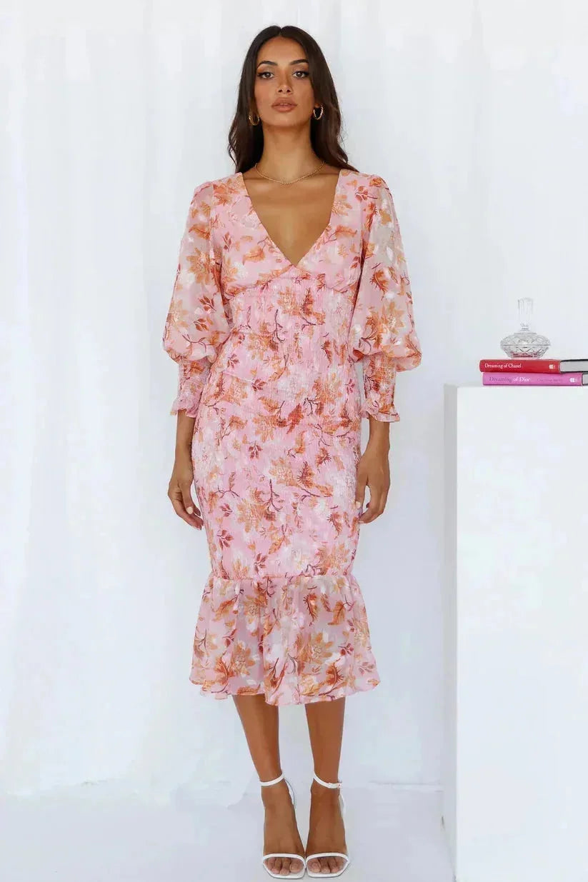 Pink floral midi dress with flared sleeves, perfect for a spring day out. Made from lightweight fabric with a charming…