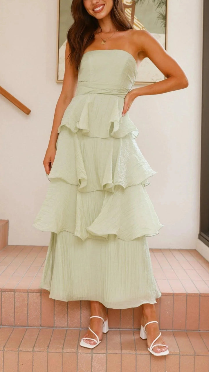 Strapless tiered maxi dress in coral with ruffles, perfect for summer.