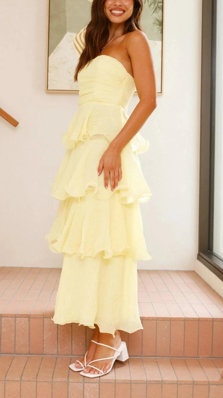 "Strapless tiered maxi dress with ruffles in flowing fabric, perfect for a summer day out"