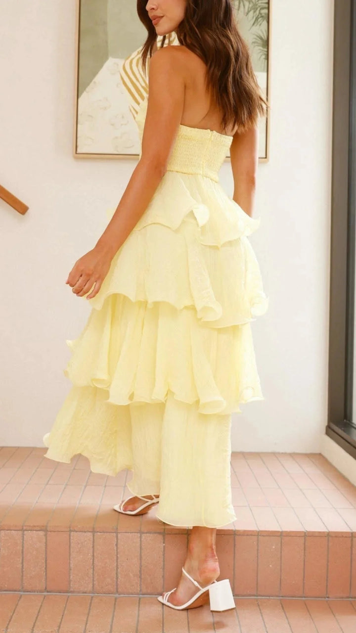 Off-white strapless dress with tiered ruffles, made with lightweight cotton fabric, perfect for summer events and beach…
