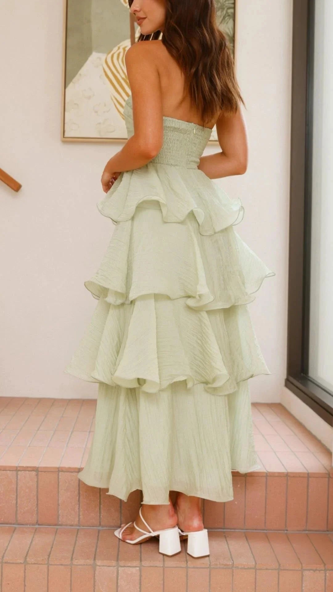 "Black strapless tiered maxi dress with ruffles made from flowy crepe fabric for a chic and stylish look."