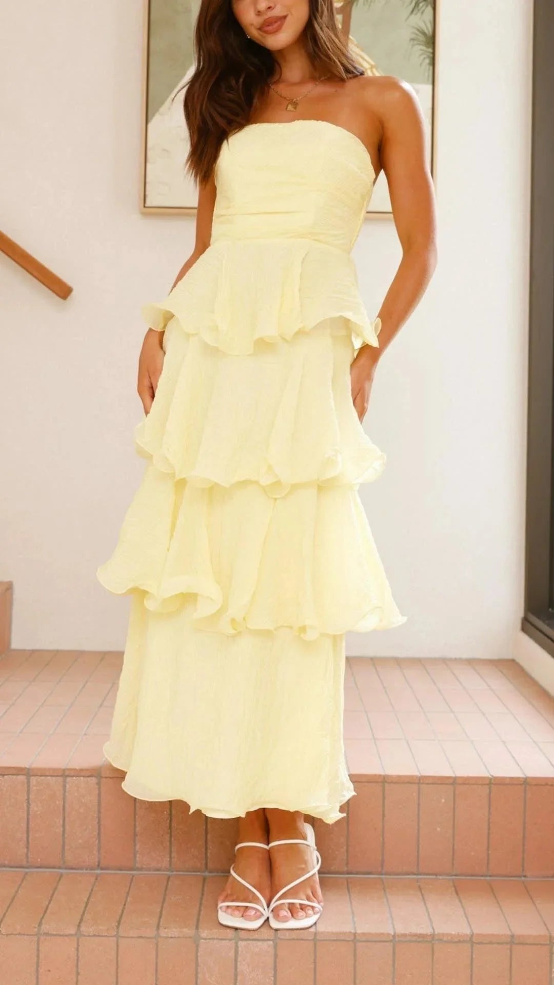 Yellow strapless maxi dress with tiered ruffles, perfect for summer days. Made from soft flowy fabric for all-day comfort.