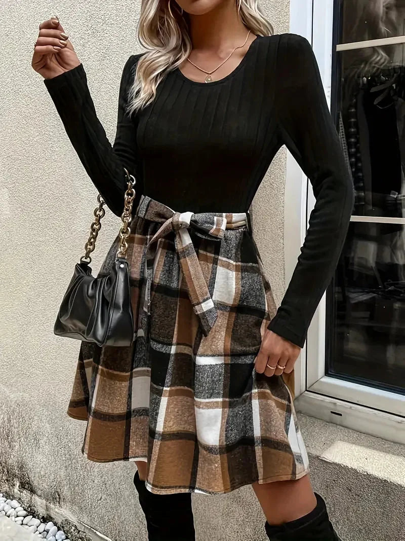 Kyndal black long sleeve top and plaid skirt dress, a stylish and versatile outfit perfect for everyday wear.