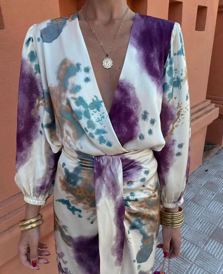 "Women's satin wrap dress featuring artistic print in shades of blue and gold"