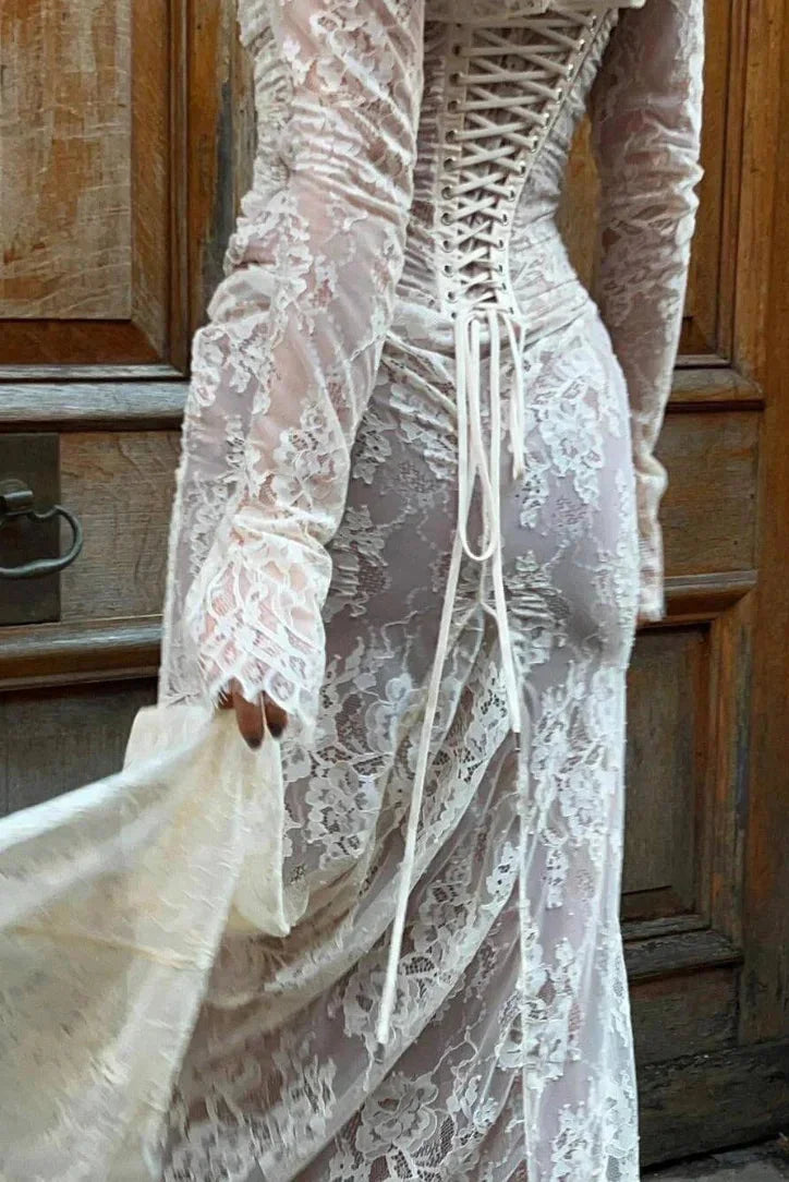 White fitted lace dress with sheer sleeves, elegant floral lace pattern and delicate detailing, perfect for special…